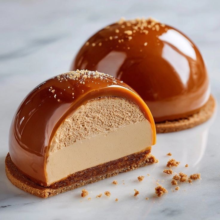 A caramel-glazed dome on a biscuit base, cut to show the mousse inside